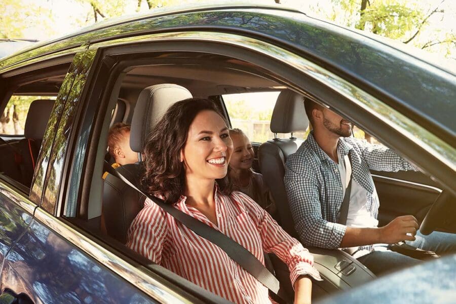 Auto Insurance - Family Driving to a Vacation Destination with Kids in the Back of the Car