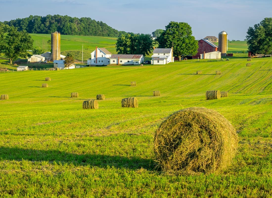 About Our Agency - Round Hay Bales on Slightly Rolling Hills in Amish Country