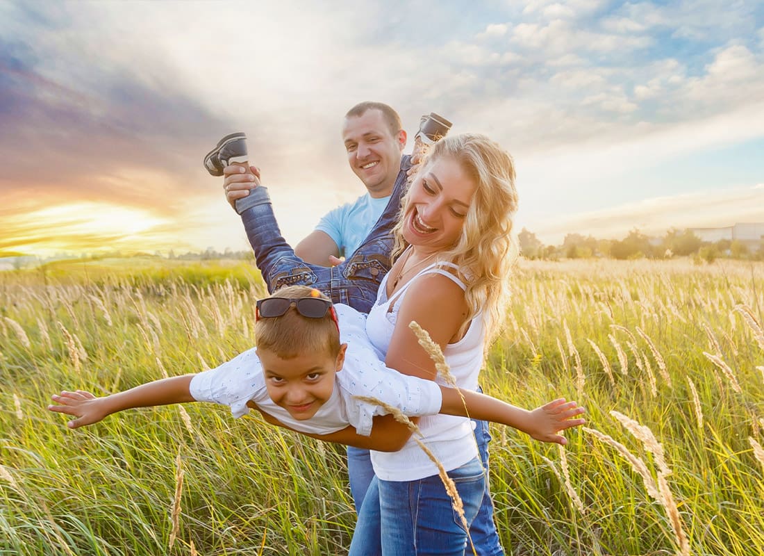 Personal Insurance - Happy Family Spending Time Together and Having Fun in Spikelet Field